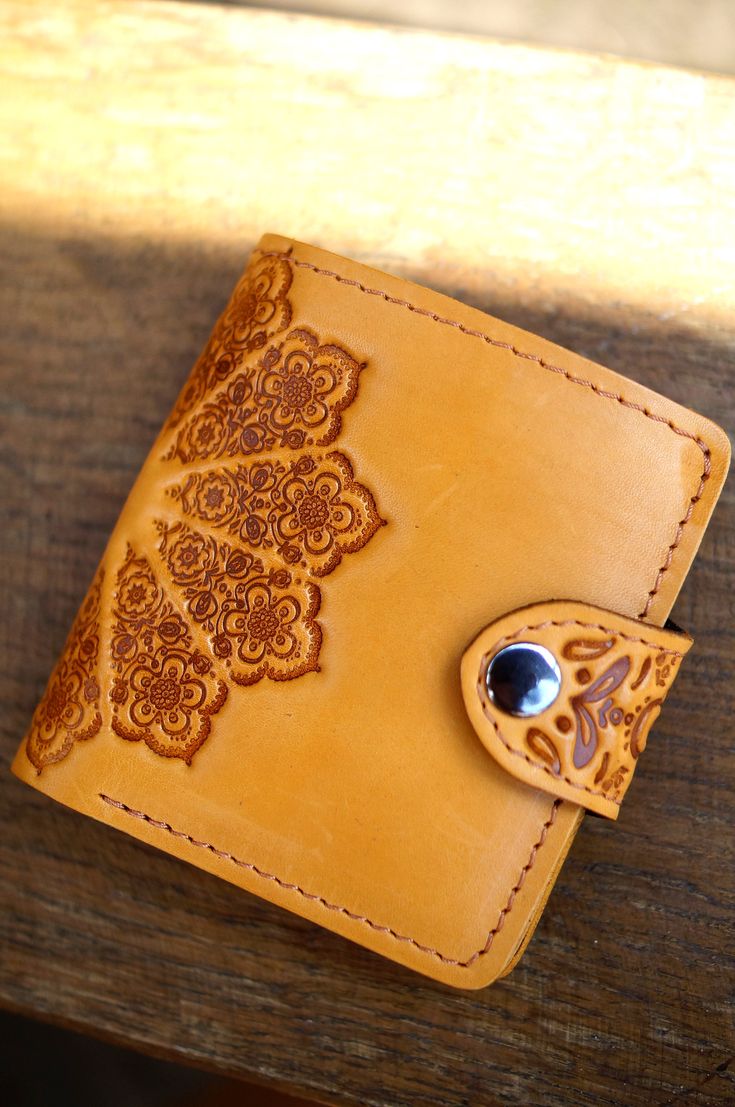 "This stylish wallet is made of high quality sturdy natural cow leather. Simplicity and elegance are combined in this charming accessory! Pure pleasure to have it in your hands! Dimensions (external, folded): 105x98mm / 4.1x3.9in Materials: natural leather (cow leather) Color: yellow Pattern: sun / oriental Style: variable Inside: one compartment for money, sections for cards and a special compartment for coins. PERSONALIZATION Make your item even more special with personalization: laser engravi Hand Tooled Leather Trifold Wallet As Gift, Hand Tooled Bifold Wallet As Gift, Brown Hand Tooled Trifold Wallet As Gift, Luxury Handmade Leather Trifold Wallet, Handmade Yellow Wallets For Daily Use, Elegant Hand Tooled Leather Wallets, Elegant Yellow Leather Wallet, Artisan Hand-tooled Bifold Wallet, Gift For Traveler