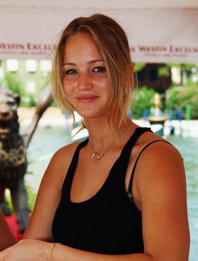 a woman standing in front of a statue