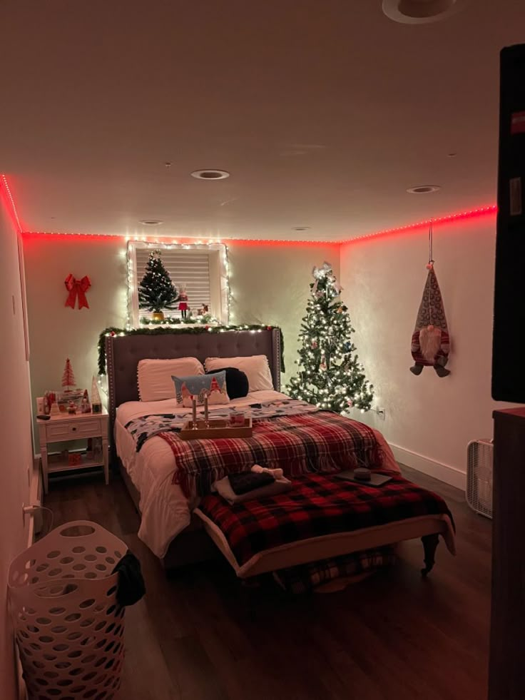 a bed room with a neatly made bed and christmas decorations