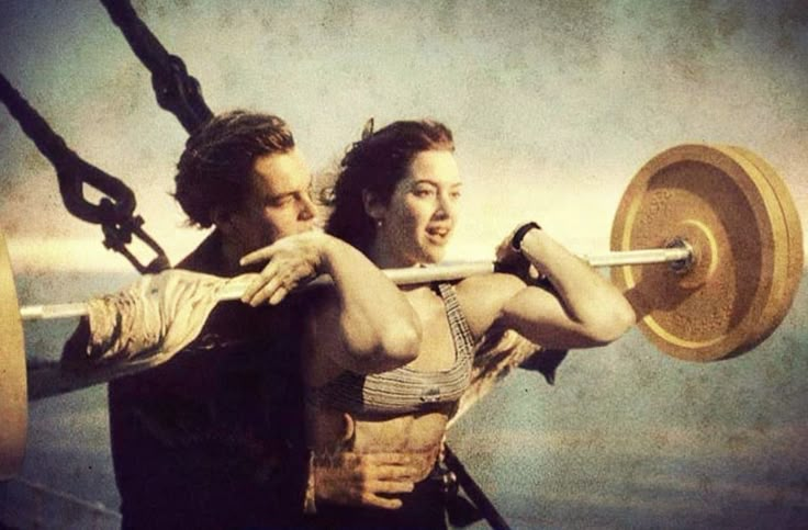 a man and woman are holding barbells in front of the ocean with a quote above them