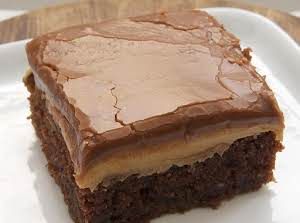 a close up of a piece of cake on a white plate with the words peanut butter fudge cake