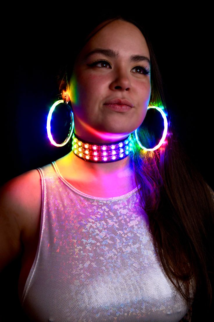 Expand your glow-filled wardrobe with the LED Choker Necklace. This colorful accessory features bright LED lights that respond to music, flashing and glittering to the beat of your favorite songs. Adjustable around your neck, this choker sits comfortably, and the battery pack fits comfortably on your back, so you hardly notice it's there. This quality-crafted sound-reactive LED Choker Necklace is a must for night concerts, festivals, and rave parties. It has bright, colorful lights that glitter Glow Party Outfit, Led Necklaces, Rave Jewelry, Uv Paint, Constellation Earrings, Glowing Necklace, Rave Accessories, Creative Accessories, Colorful Lights