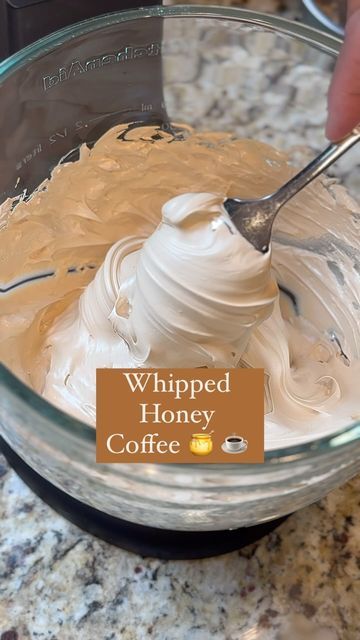 whipped honey coffee in a glass bowl being stirred by a spoon with a sign that reads whipped honey coffee