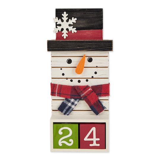 a wooden block with a snowman wearing a hat and scarf