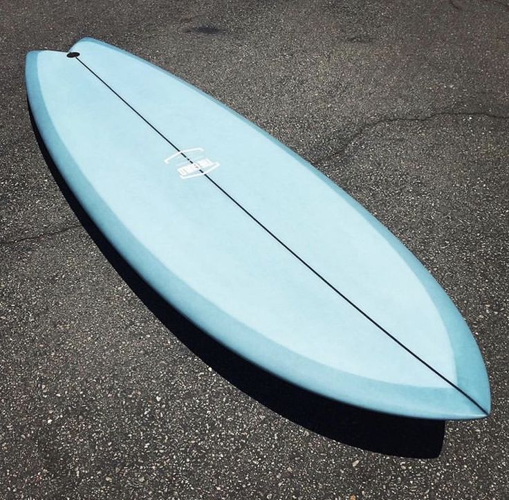 a blue surfboard laying on the ground