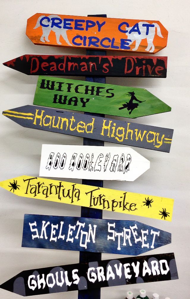 a wooden sign with many different types of signs attached to it's sides and the words creepy cat circle, deadman's drive, hitchhik's way, harry, haunted highway,