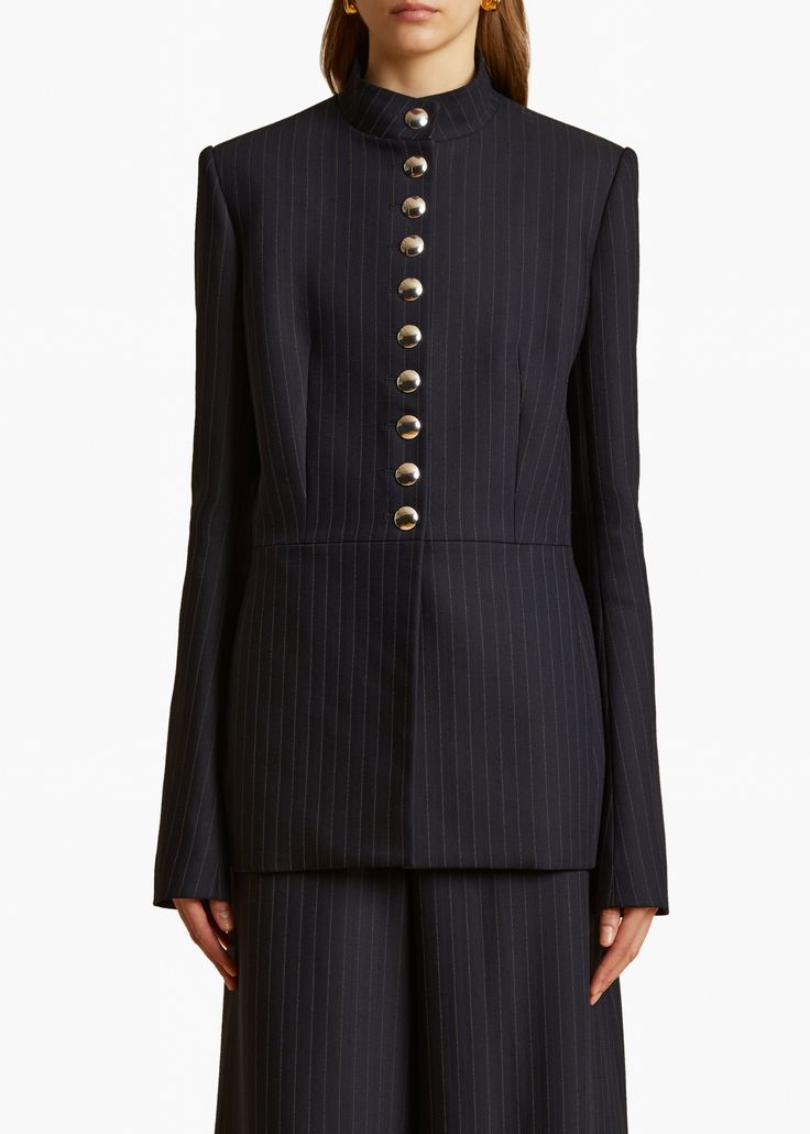 A close-fitting, stand-collar jacket traced by chalk stripes. Lined with trompe l'oeil buttons reprised at the cuffs, the placket conceals internal snaps. Stand Collar Jackets, Abaya Designs, Wool Blend Jacket, Winter Wear, Navy White, Stand Collar, Suits For Women, Navy And White, White Stripe