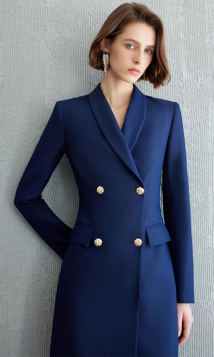 Exude Confidence with the Navy Double-Breasted Blazer Dress Step into a world of refined elegance with our Navy Double-Breasted Blazer Dress—the epitome of power dressing for the modern woman. This dress combines the sharp tailoring of a blazer with the femininity of a dress, creating a look that is both authoritative and elegant. Crafted from high-quality fabric, it features a sleek navy hue, structured shoulders, and gold-tone buttons that add a touch of luxury. The long sleeves and tailored f Elegant V-neck Blazer For Semi-formal Occasions, Elegant V-neck Semi-formal Blazer, Structured Fitted Blazer Dress With Buttons, Elegant Evening Blazer Dress With Suit Collar, Elegant Structured Blazer Dress For Formal Occasions, Elegant V-neck Blazer Dress For Office, Elegant Tailored Blazer Dress With Lapel Collar, Elegant Structured Single-breasted Blazer Dress, Elegant Blazer Dress With Lapel Collar