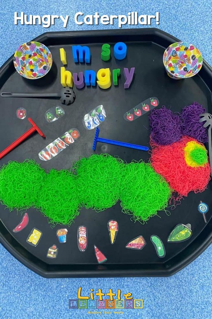 a child's play time clock made out of yarn and plastic beads with the words hungry caterpillar on it