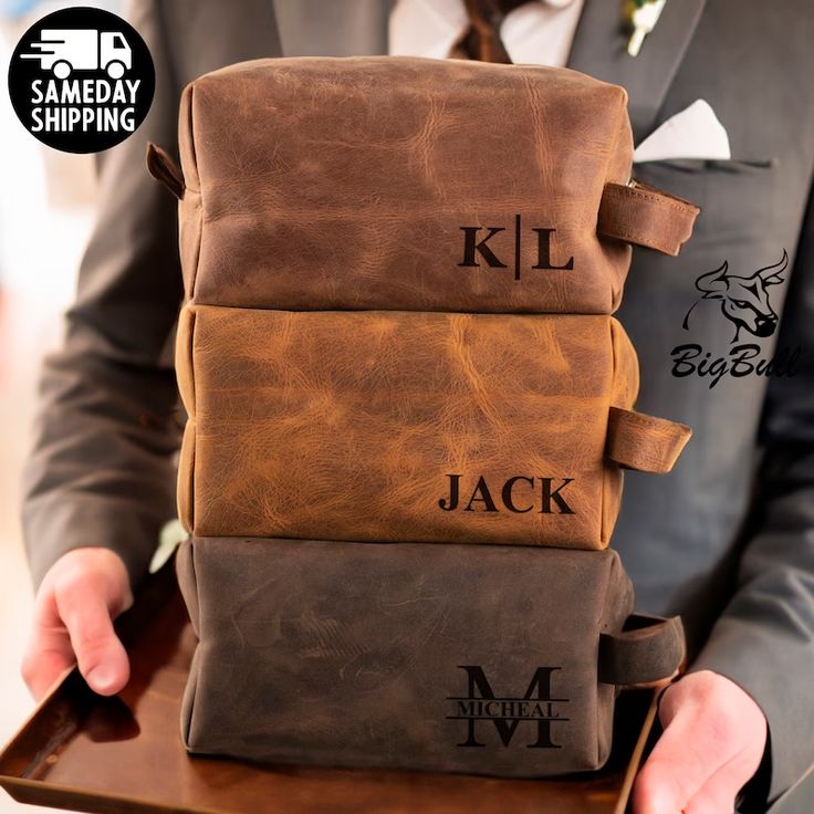 a man in a suit holding three brown bags with initials on them and the words kl, jack written across each bag