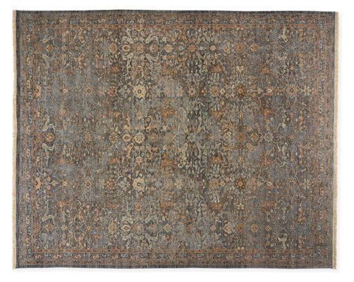 an antique rug with many different colors and patterns