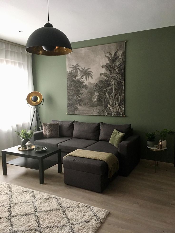 a living room filled with furniture and a painting on the wall