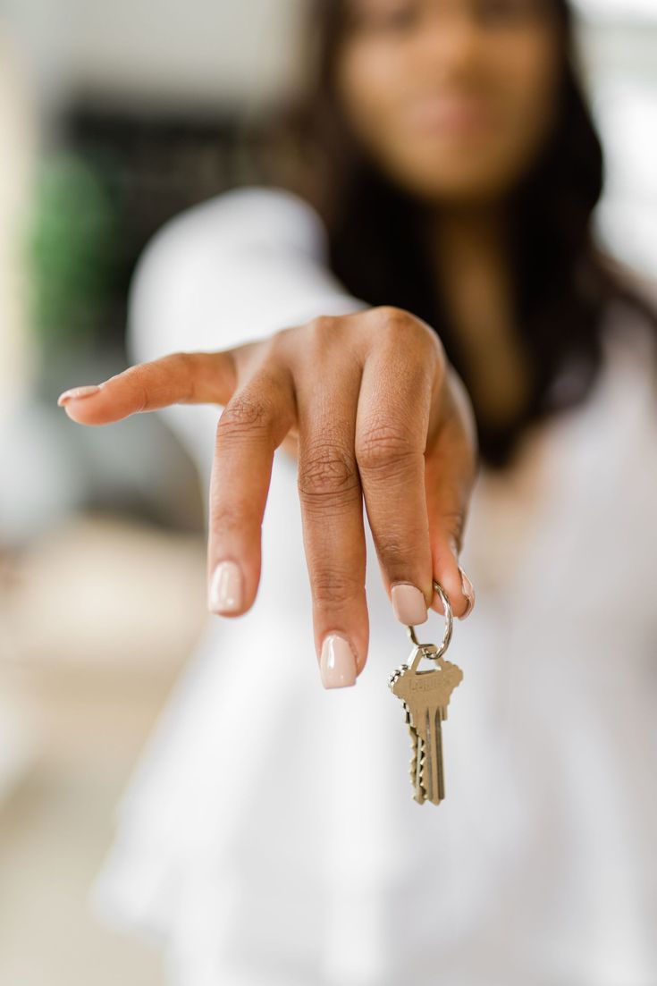 a woman holding a key to her house