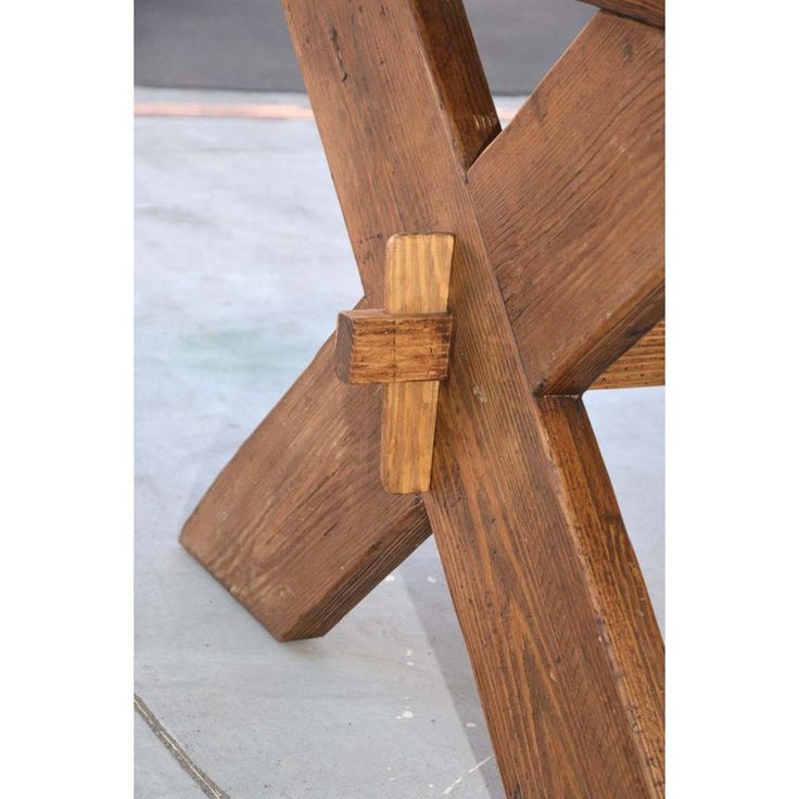 a close up of a wooden bench on concrete