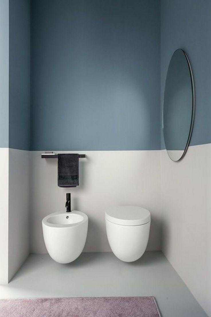 two white sinks in a bathroom with blue walls