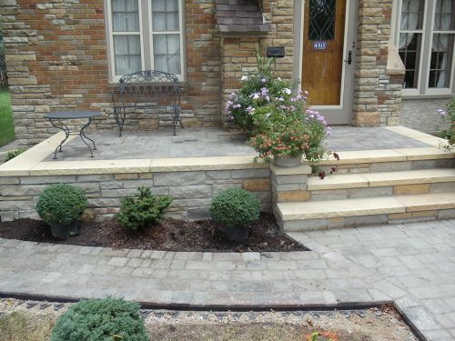 an outdoor patio with steps leading to the front door