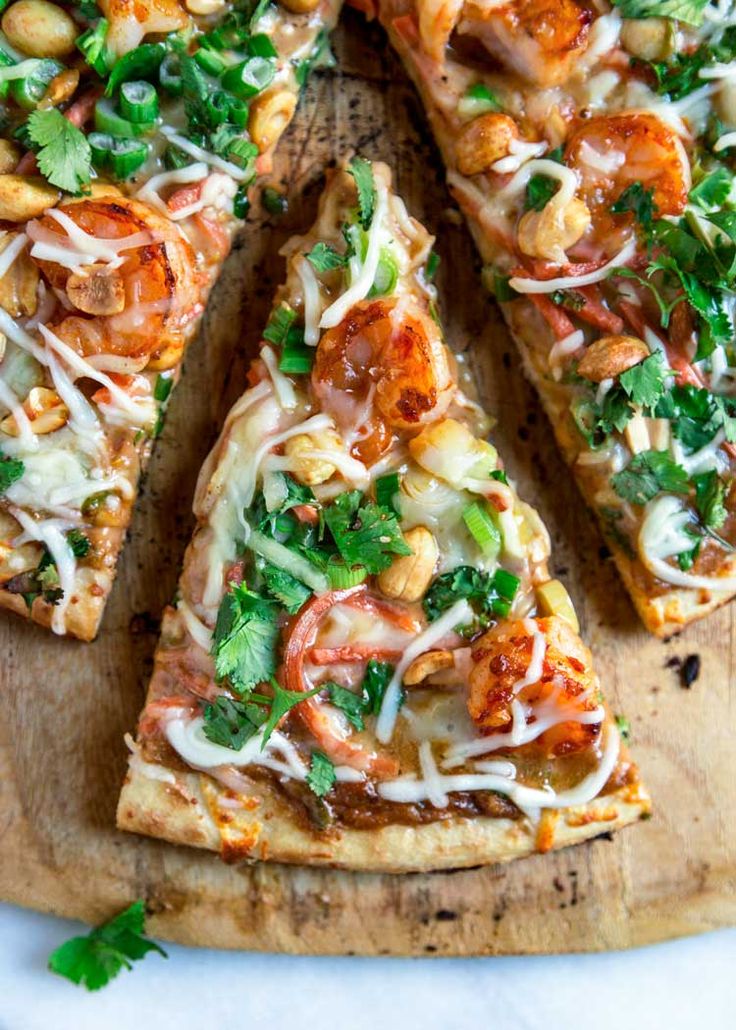 several slices of pizza on a wooden cutting board