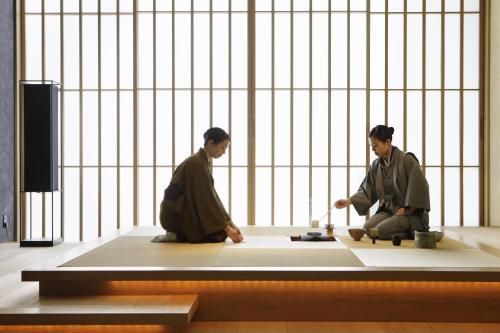 two people sitting on top of a table