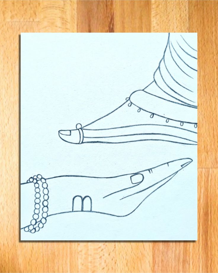 a piece of paper with a drawing of a foot on it and a chain around the ankle