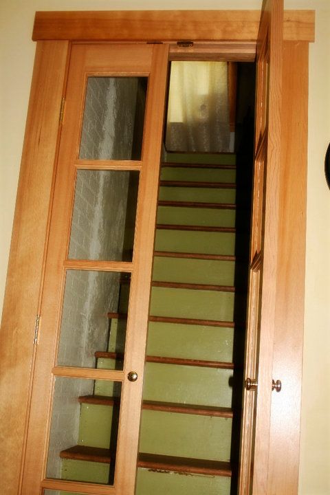 an open wooden door leading to a stairway