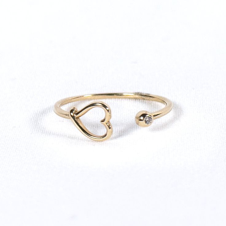 Experience unique charm with our Claw Ring with Heart. Crafted in 10K solid gold, this captivating ring features a delicate heart nestled within an intricately designed claw, adding a touch of edgy elegance and romance to your look. 10K Yellow Gold White Zirconia Adjustable Heart-shaped Yellow Gold Midi Rings, Tarnish Resistant Open Heart Promise Ring, Tarnish-resistant Open Heart Promise Ring, 14k Gold Heart Shaped Open Ring For Promise, 14k Gold Open Heart Ring For Promise, 14k Gold Heart Ring With Birthstone For Promise, Adjustable Heart Charm Ring For Promise, Gold Heart-shaped Midi Rings For Promise, Gold Heart Midi Rings For Promise