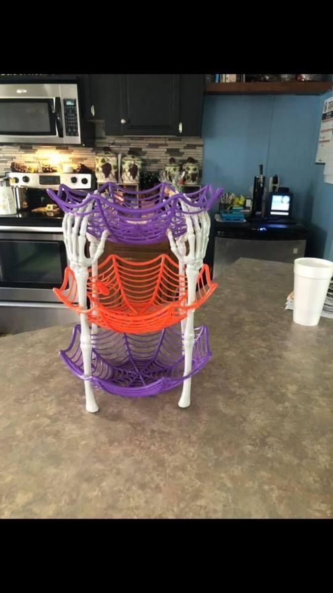 a kitchen counter topped with purple and orange shelves