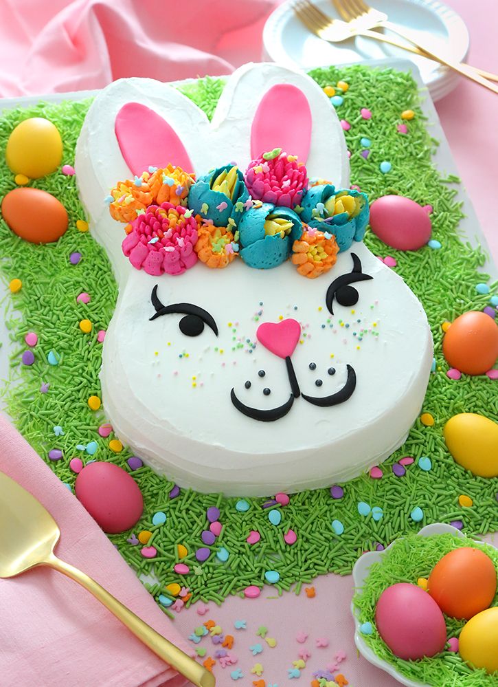 an easter bunny cake with sprinkles and decorations on the top is ready to be eaten