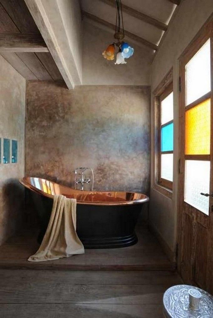 an old fashioned bath tub in a rustic bathroom