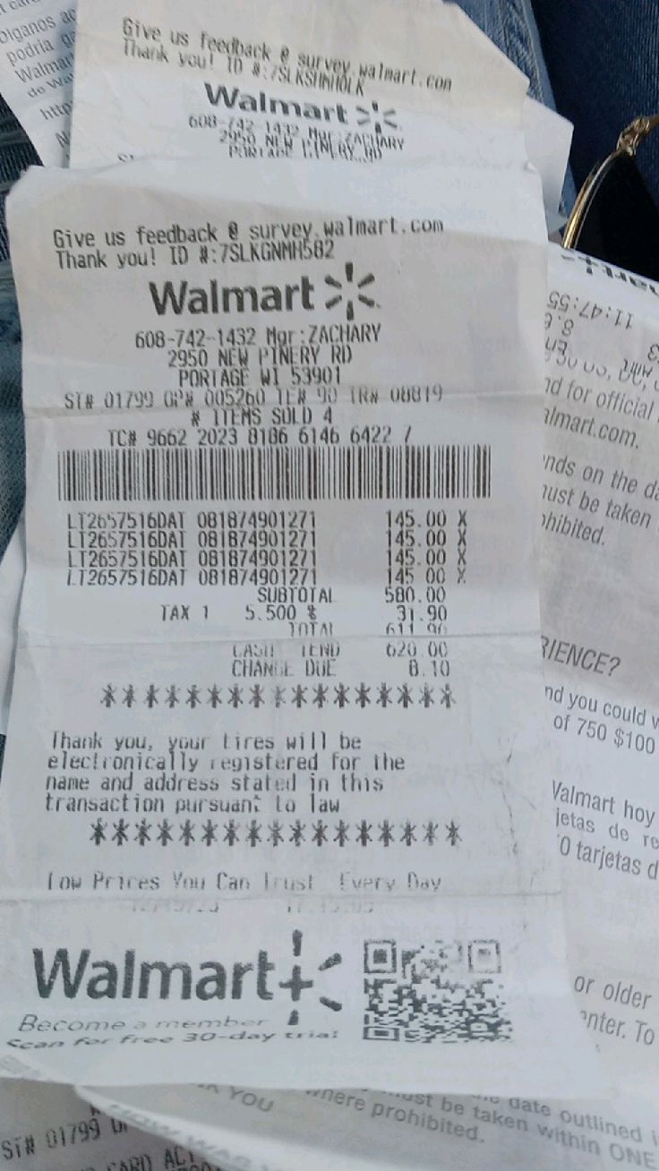 the receipt for walmart has been placed on someone's jeans and they are stacked up