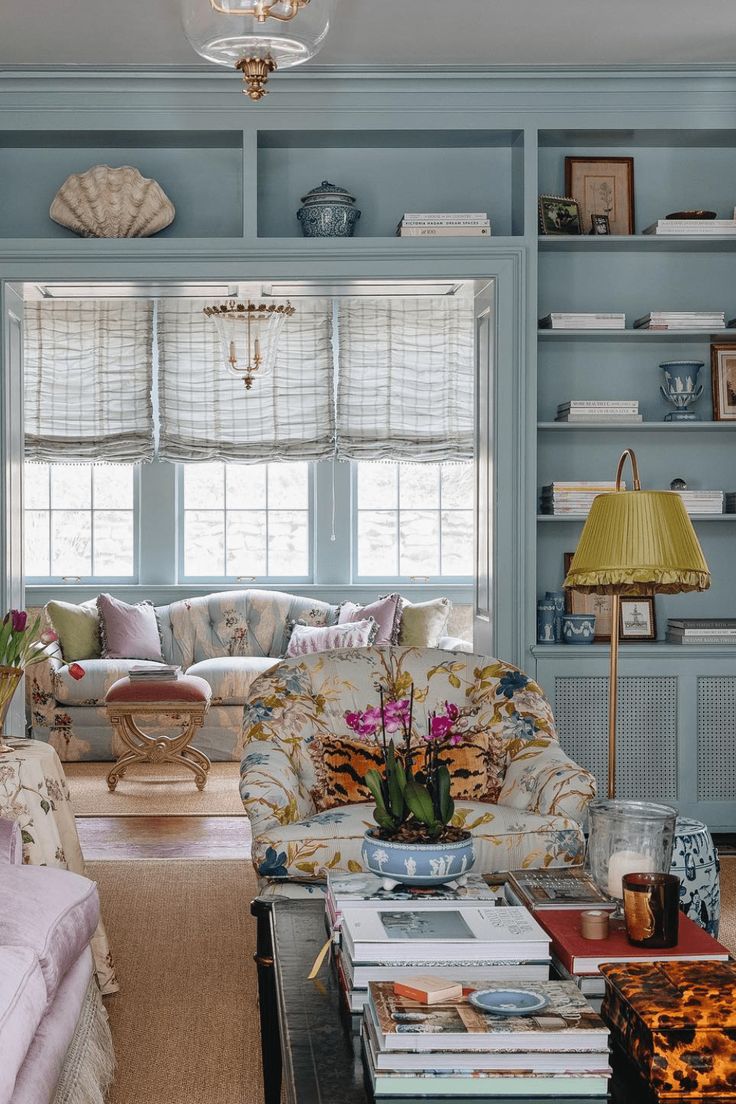 a living room filled with furniture and bookshelves