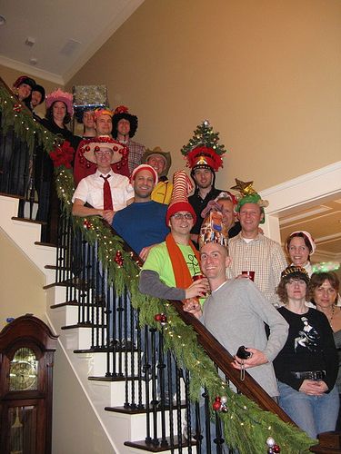 a group of people standing on top of a set of stairs with christmas decorations around them