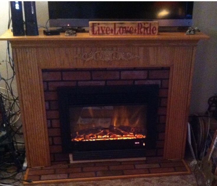 a fire place with a television above it