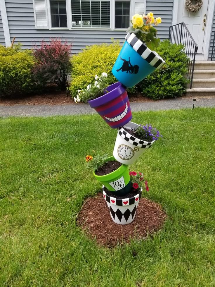 a stack of buckets on top of each other in the grass