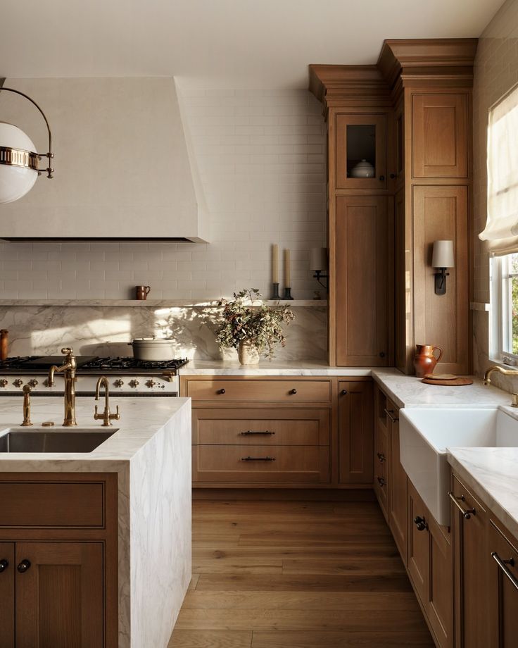 a kitchen with wooden cabinets and white counter tops, along with a large center island