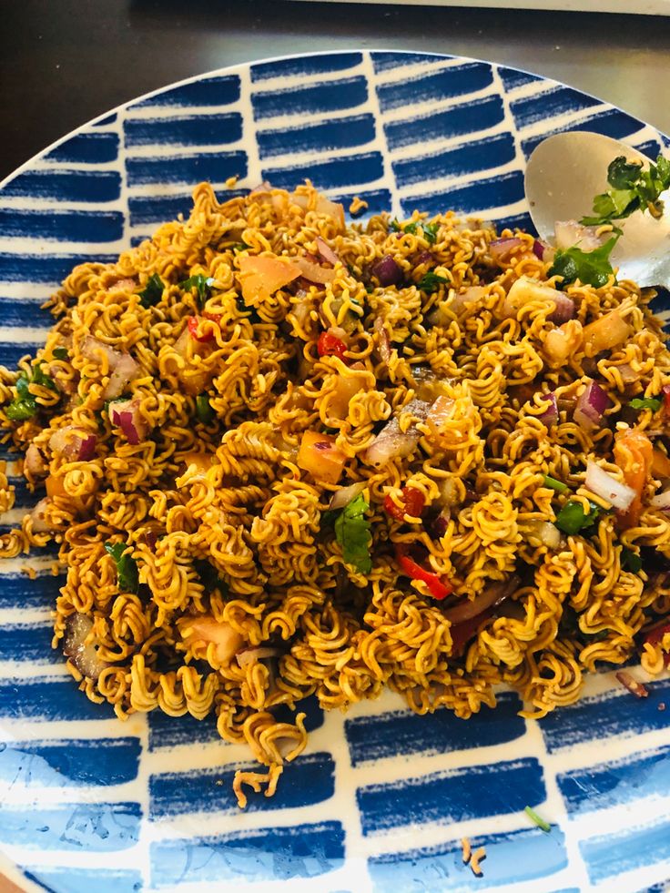 a blue and white plate topped with noodles