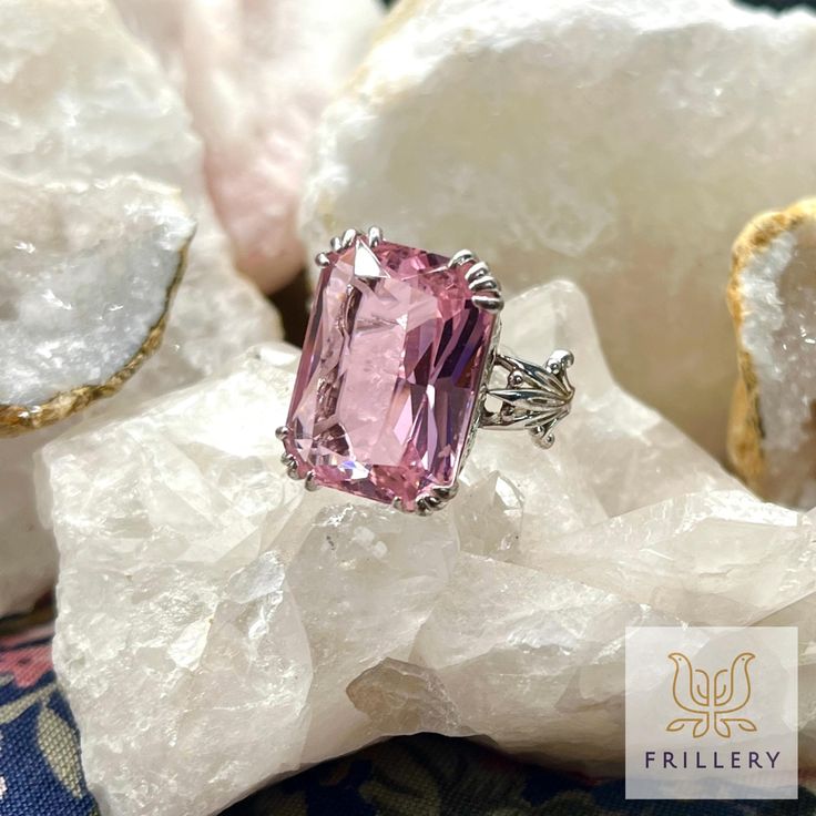 Stand out from the crowd with this exquisite ring that combines classic elegance with a touch of pink perfection. The intricate detailing on this stunning piece will have you feeling like a true fashion icon wherever you go. Size 5. Like so many of Frillery's vintage and thrifted pieces, this one might show minor signs of age or wear. Formal Pink Ruby Ring With Accent Stones, Pink Ruby Ring With Accent Stones For Formal Occasions, Elegant Pink Gemstone Ring, Elegant Pink Ruby Ring With Center Stone, Pink Open Ring With Prong Setting Jewelry, Pink Open Ring Jewelry With Prong Setting, Pink Prong Set Open Ring Jewelry, Pink Open Ring With Prong Setting, Classic Pink Ring Jewelry