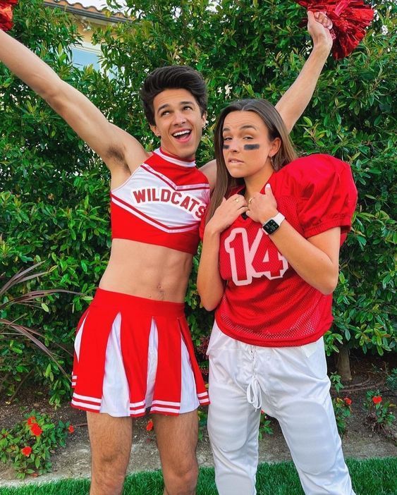 a man and woman dressed in cheerleader outfits