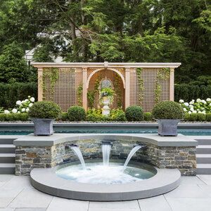 an outdoor fountain in the middle of a garden