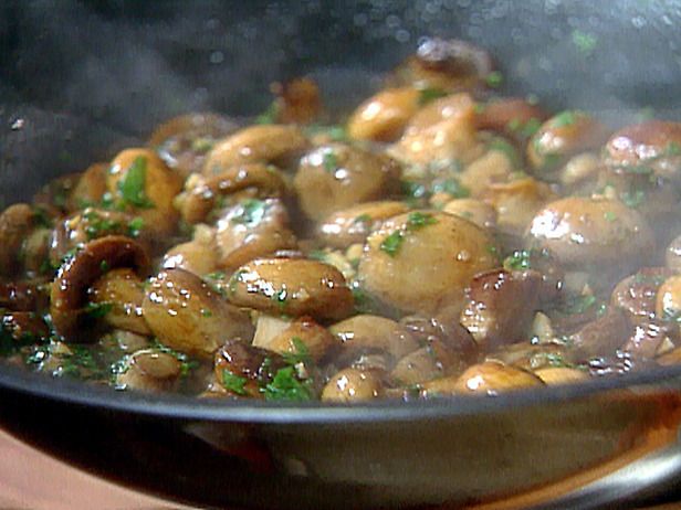 mushrooms are being cooked in a pan on the stove