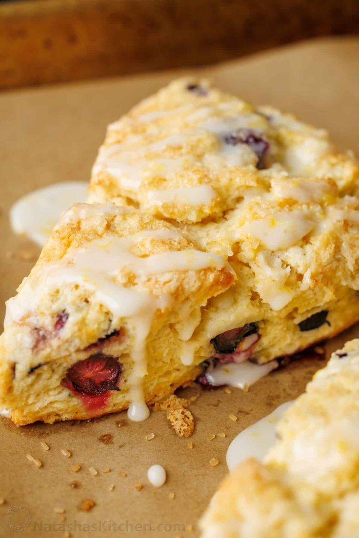 a close up of food on a piece of paper with icing and strawberries