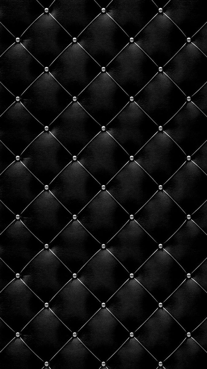 a black leather upholstered background with rivets