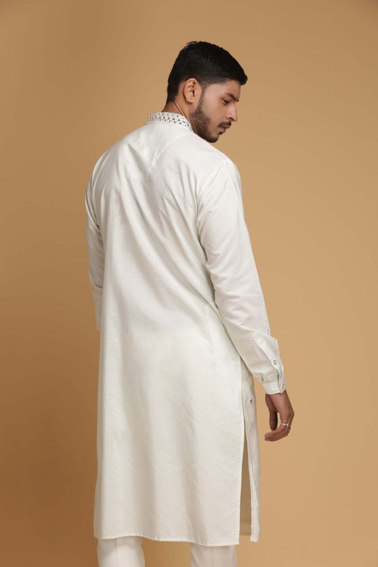 Editor's Note This set features Kurta and Pyjama Color: Ivory Fabric: Cotton Silk Care: Dry Clean Only About the Designer Inspired By The Minimalism, Utilitarianism And Functionality, Chatenya Mittal Is A Label Focused Entirely On Menswear. Chatenya Mittal Is Revisiting The Classic Silhouette Bringing New Energy And Working To Create Future Classics By Subtly Combining Fabric Blocking, Layering, Attention To Detail And By Developing It Further With The Addition Of Innovative Materials And Use Of Cotton Pant Set With Straight Kurta For Wedding, Off-white Long Sleeve Kurta With Dabka, Beige Long Sleeve Cotton Lawn Suit, Off White Cotton Kurta With Dabka, Cream Long Sleeve Kurta With Dabka, Off White Fitted Long Sleeve Kurta, Fitted Long Sleeve Off White Kurta, Cream Cotton Straight Kurta, White Cotton Sherwani With Long Sleeves