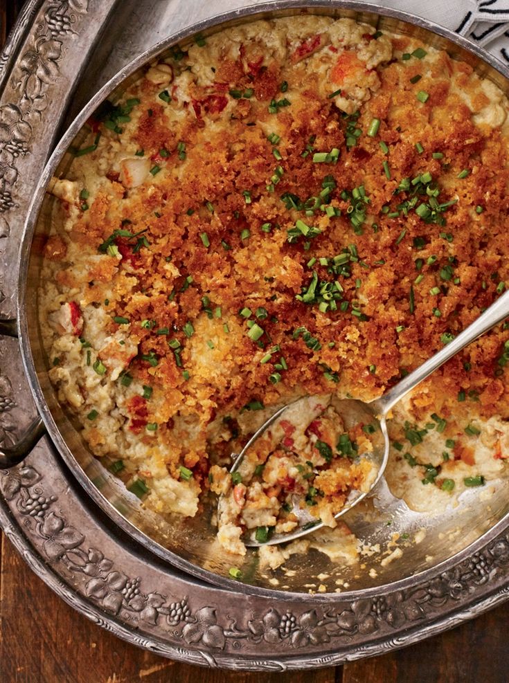 a casserole dish with meat and vegetables in it on a silver platter