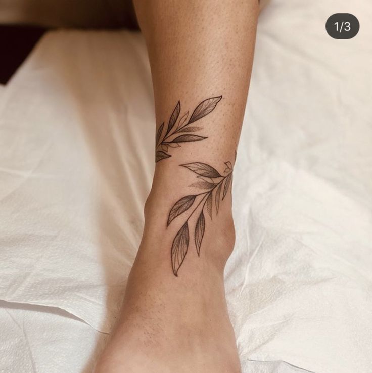 a woman's foot with a leaf tattoo on her left ankle and the bottom part of her leg