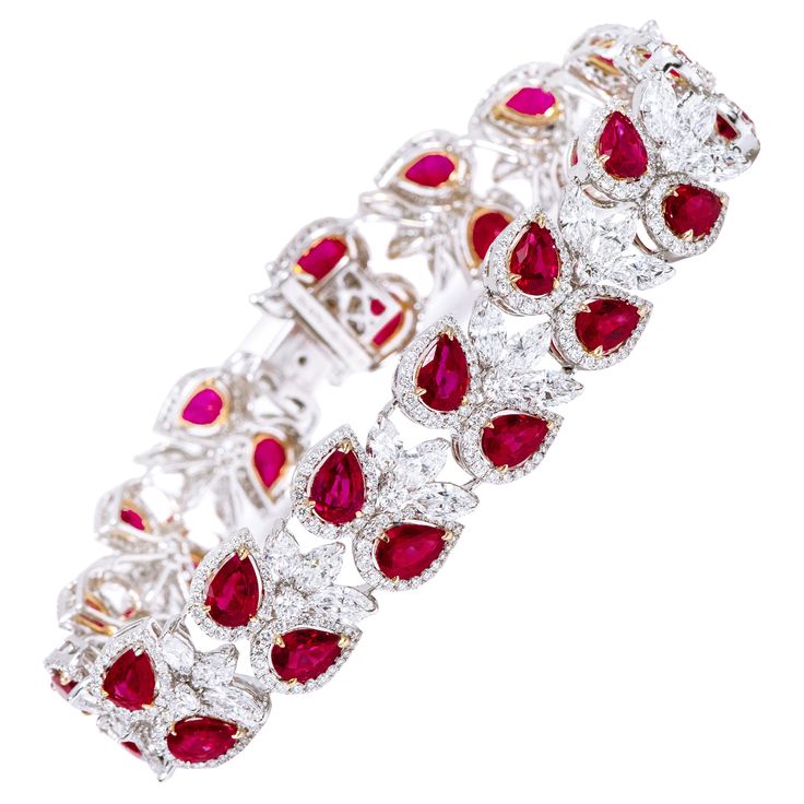 18 Karat Gold 26.22 Carat Ruby and Diamond Cocktail Statement Tennis Bracelet This incredulous blood-red ruby and diamond solitaire broad flexible bracelet is impressive. The solitaire pear-shaped ruby is surrounded by a single row of slightly gaped pave diamond cluster magnifying its look and grace. The beautiful outward angling of the rubies create the perfect element to mesmerize the senses vividly. The addition of solitaire round and marquise diamonds in the up and down leveling and amicable Argentium Silver Jewelry, Bracelet Stand, Chanel Bracelet, Flexible Bracelet, Bracelet Tennis, Ruby Bracelet, Modern Bracelets, Holly Berry, Red Diamond