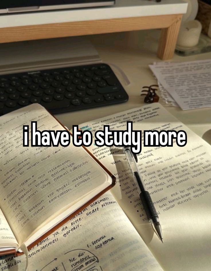 an open book sitting on top of a desk next to a keyboard