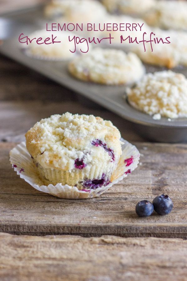 lemon blueberry greek yogurt muffins on a tray with fresh blueberries