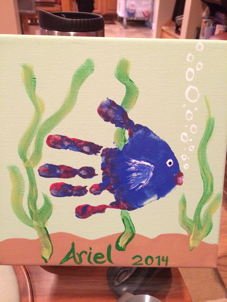 a painting of a handprinted blue fish in the ocean