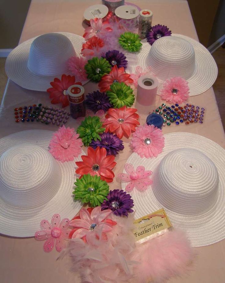 the table is covered with white plates and pink flowers