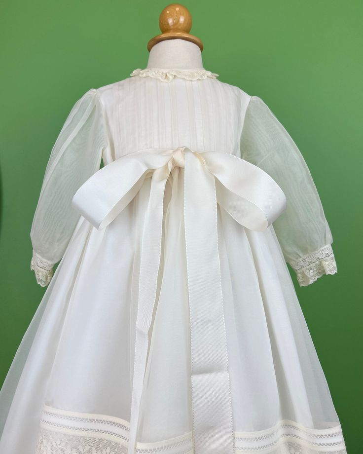 Vigo is a gorgeous and elegant baptismal gown, made in off-white lightweight organza and with floral laces. It comes with matching bonnet. It has three buttons on the back for closure. Made in Spain Dry Clean Final Sale, no exchanges nor returns will be accepted after purchase. Cream Baptism Gown With Fitted Bodice, Elegant Baptism Dress With Lace Trim And Organza, Elegant First Communion Gown With Lace Sleeves, Elegant Gown With Lace Sleeves For First Communion, Organza Baptism Dress With Lace Bodice For Wedding, Elegant Organza Baptism Dress For Ceremony, First Communion Gown With Lace Trim And Fitted Bodice, Ceremony Baptism Dress With Lace Trim And Fitted Bodice, Cream Fitted Organza Baptism Dress